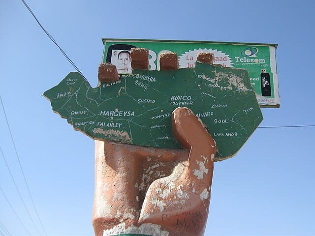 A statue of a large hand holds a green map of Somaliland in its grip